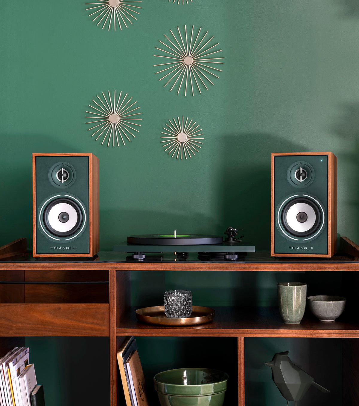 Borea speakers and a turntable against a green wall